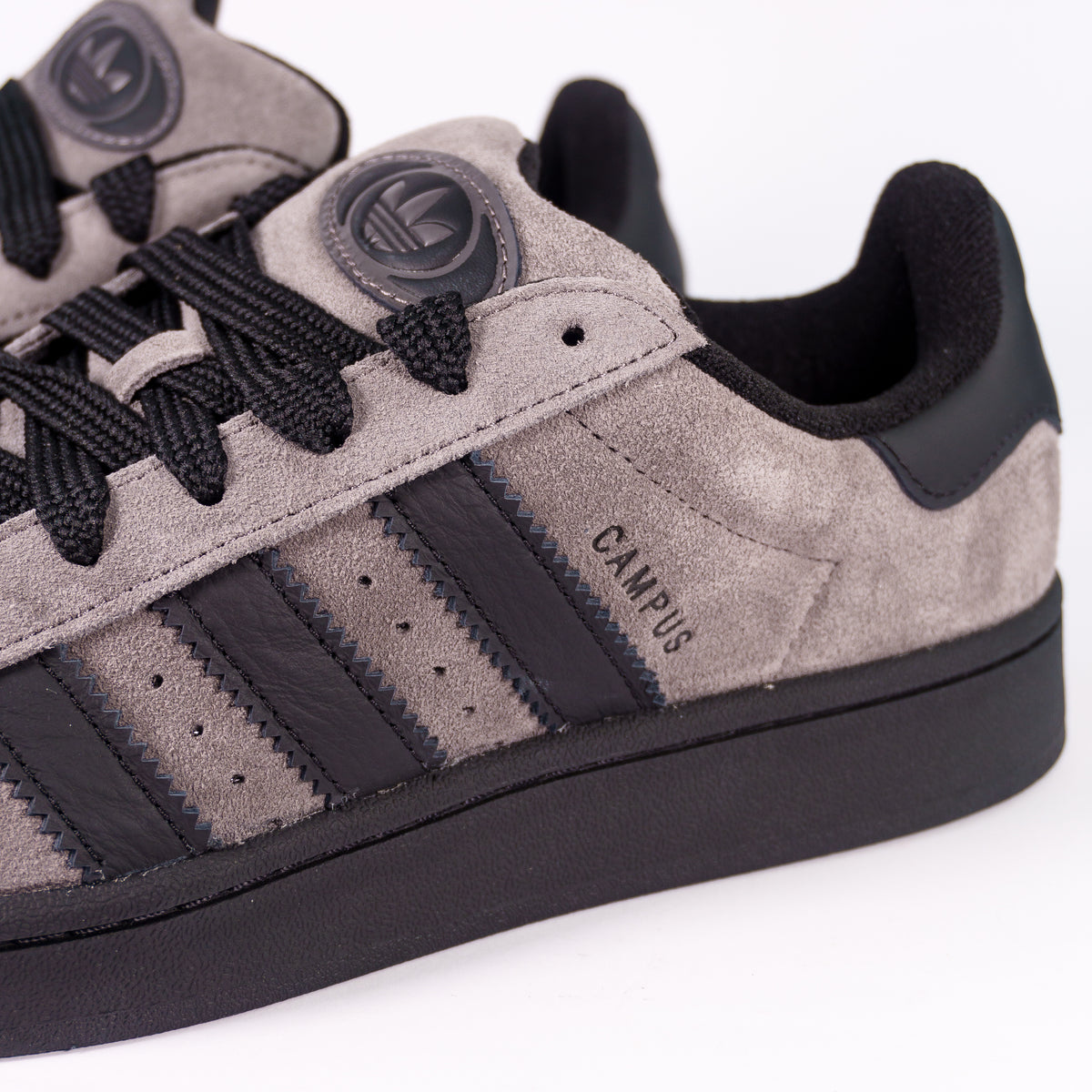 Замша Adidas Campus 00s Charcoal крупним планом: три чорні смужки і тиснений напис Campus
