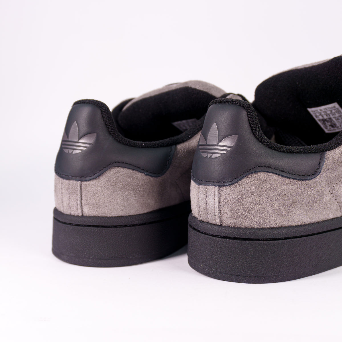 Adidas Campus 00s Charcoal Core Black — вид ззаду: чорний задник з тисненим трилисником