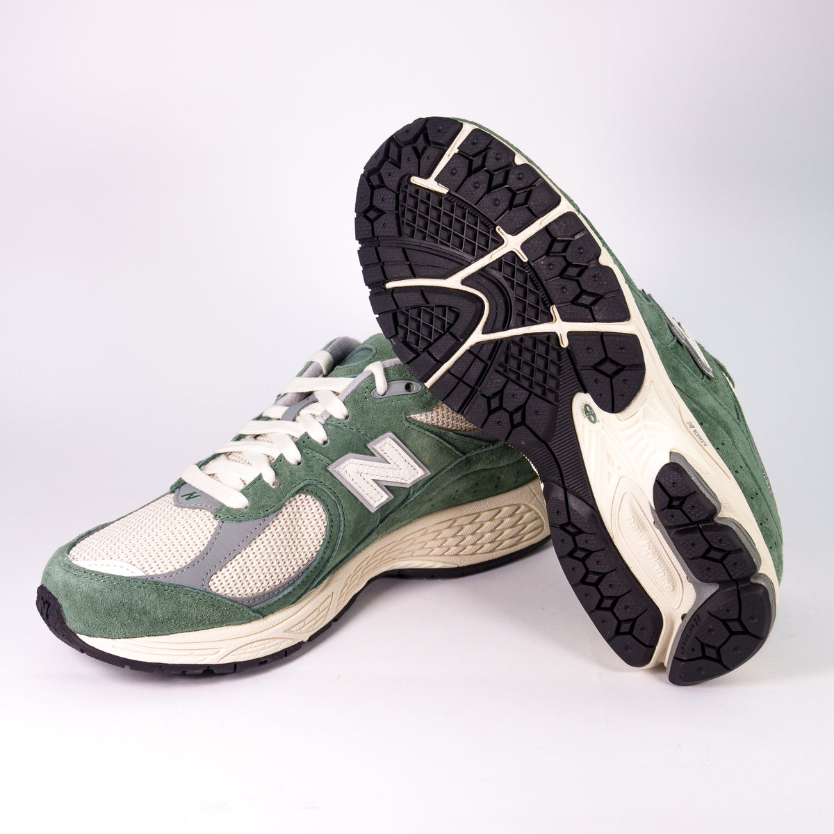 New Balance 2002R зелені збоку і чорна підошва з кремовою вставкою Stability Web